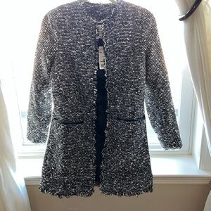 Long jacket with fringe details and 2 front pockets.